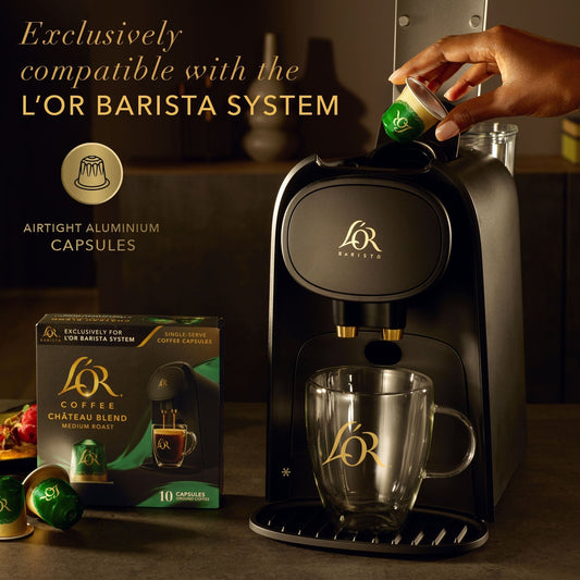 L'OR Barista System with coffee machine, capsules, and a box on a dark background