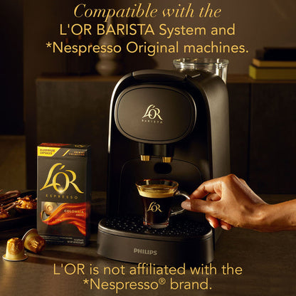 Philips coffee machine with L'OR branding, a glass of coffee, and a box of L'OR coffee on a wooden surface.